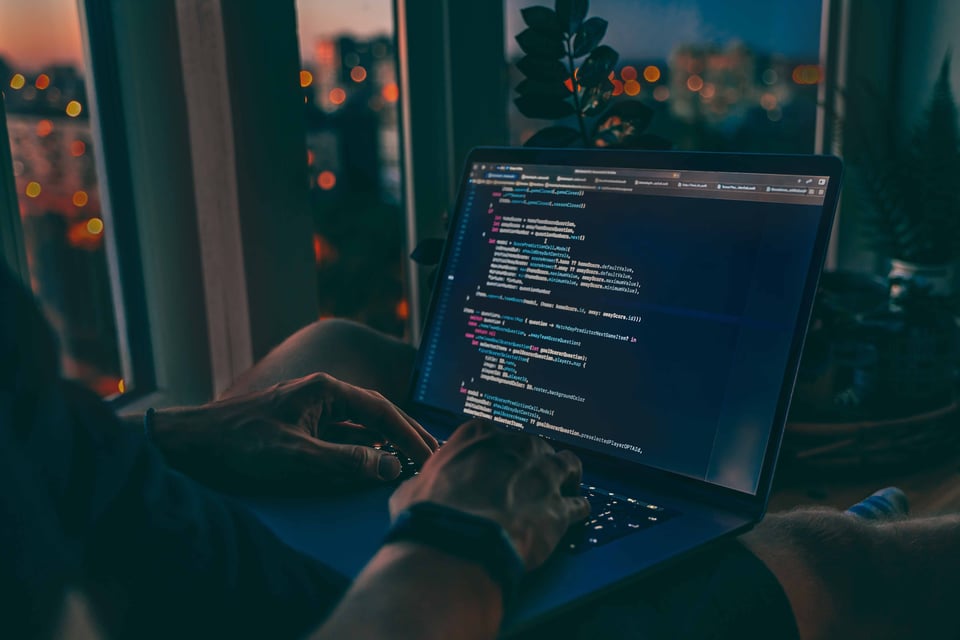 hands of developer and screen with code